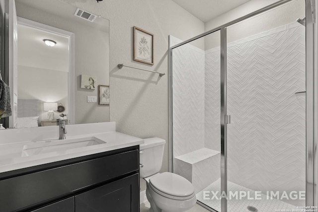 bathroom featuring walk in shower, toilet, and vanity