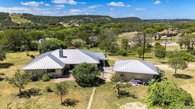 birds eye view of property with a view of trees