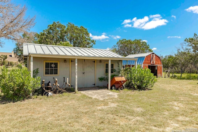 back of property with a yard and a storage shed