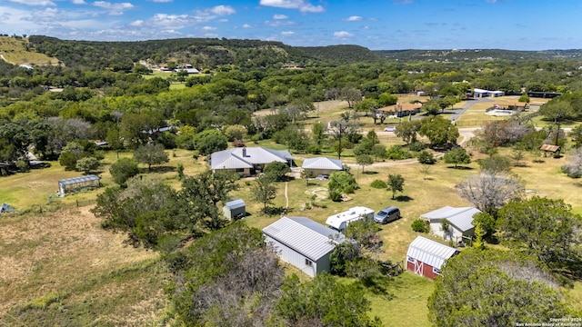 birds eye view of property with a wooded view