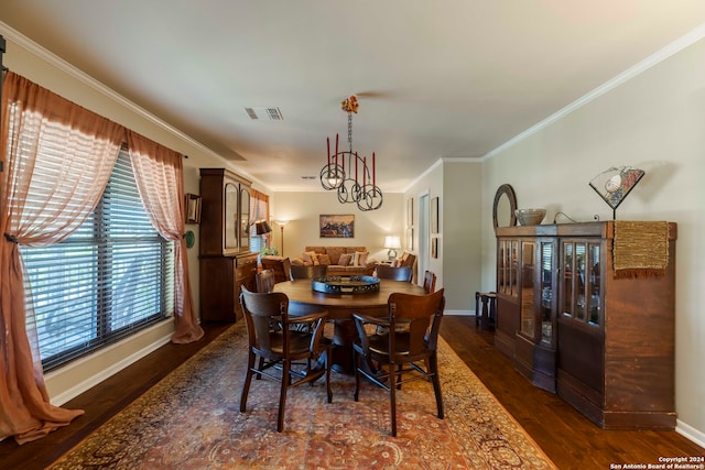 dining area with ornamental molding, a notable chandelier, and dark hardwood / wood-style floors