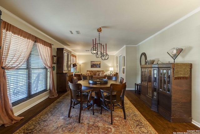 dining room with dark wood-style floors, visible vents, crown molding, and baseboards