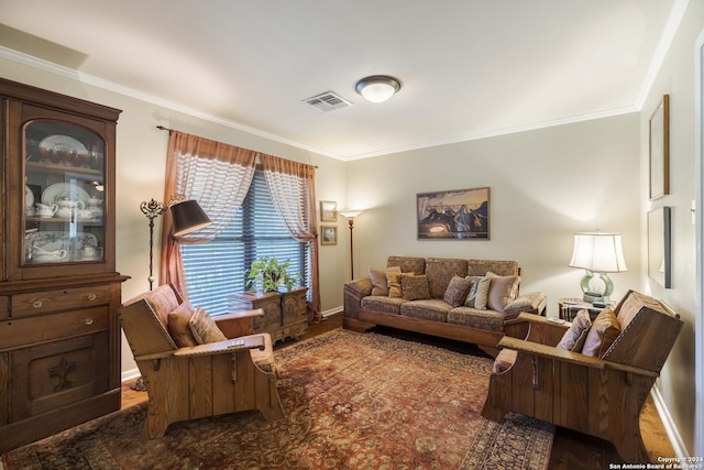 living area with baseboards, visible vents, and ornamental molding