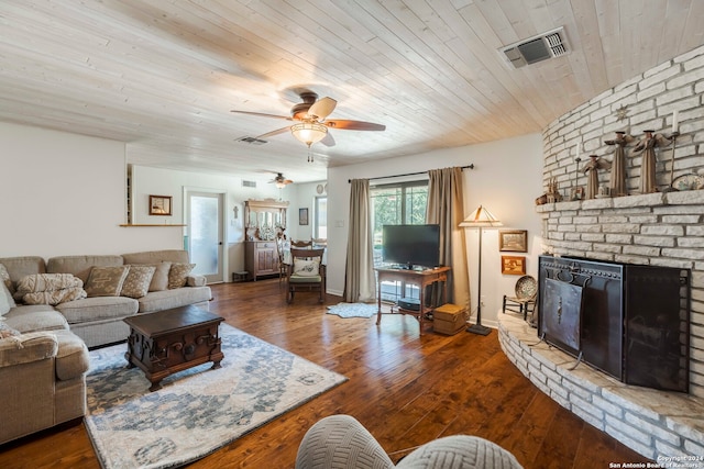 living room with wooden ceiling, hardwood / wood-style flooring, a brick fireplace, and ceiling fan