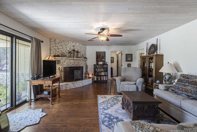 living room with hardwood / wood-style floors, ceiling fan, and a fireplace