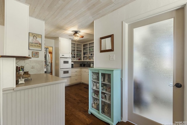 kitchen featuring white double oven, wooden ceiling, dark wood-style flooring, freestanding refrigerator, and light countertops