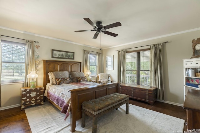 bedroom with crown molding, baseboards, and wood finished floors