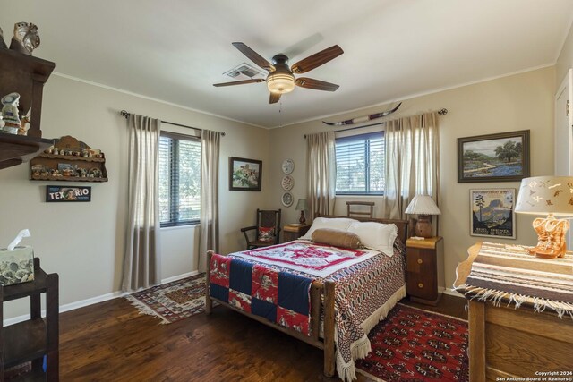 bedroom with dark wood-type flooring, multiple windows, ceiling fan, and crown molding