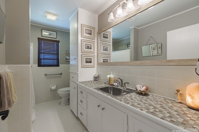 bathroom featuring toilet, ornamental molding, vanity, tasteful backsplash, and tile walls