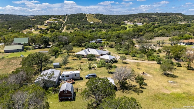 drone / aerial view featuring a forest view