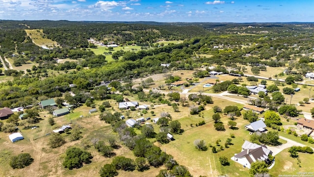 birds eye view of property featuring a forest view