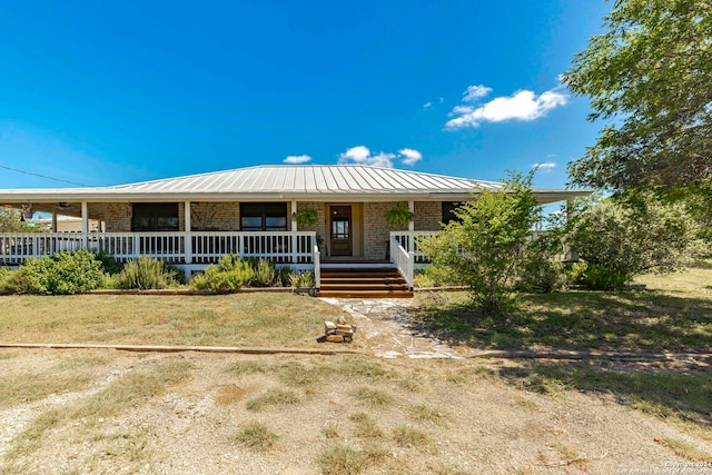 view of front of house featuring a front yard and covered porch