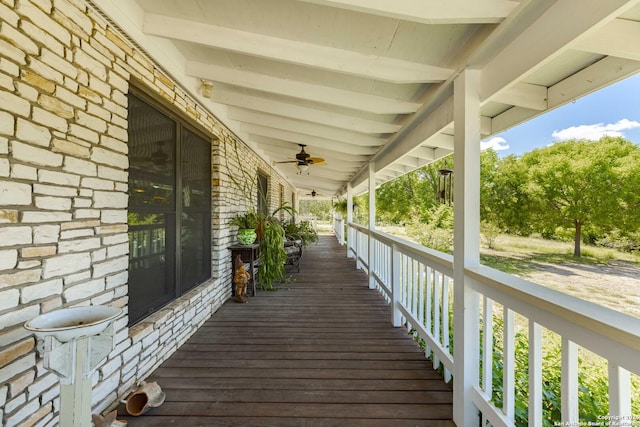 wooden deck featuring a porch and ceiling fan