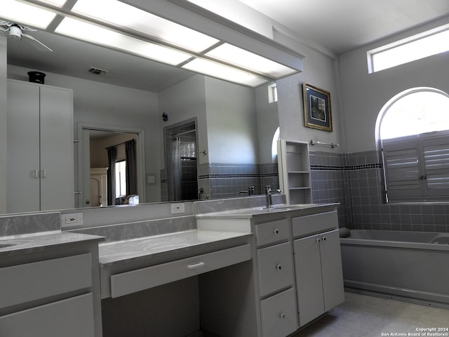 bathroom featuring vanity and shower with separate bathtub