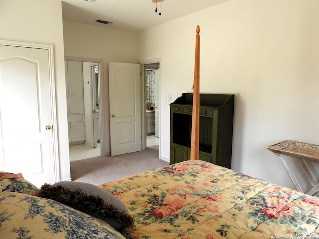 bedroom featuring light carpet and a closet