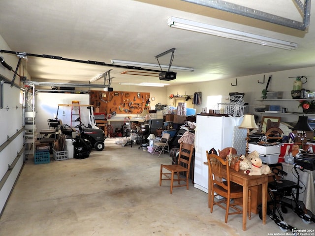 garage with a workshop area and a garage door opener