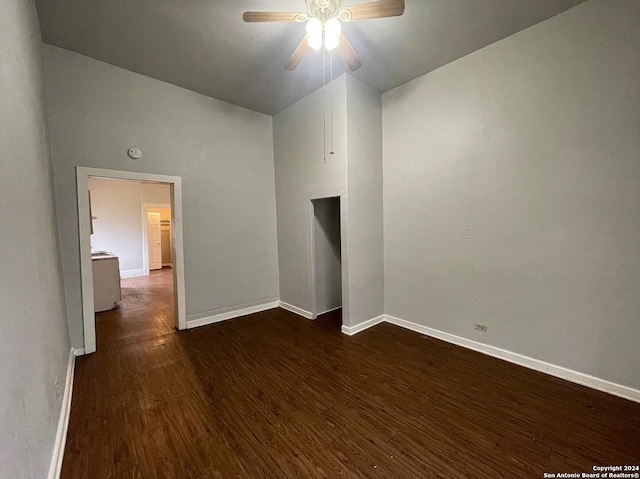 empty room with ceiling fan and dark hardwood / wood-style flooring