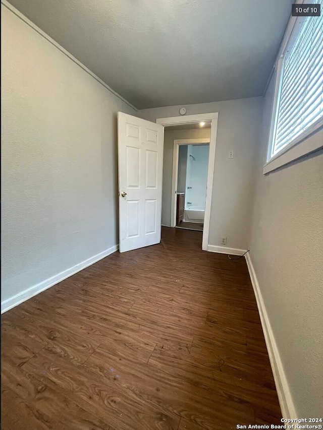 unfurnished room featuring dark hardwood / wood-style flooring