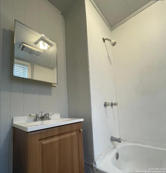 bathroom with tub / shower combination, ornamental molding, and vanity