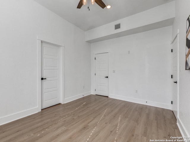 empty room featuring ceiling fan and light hardwood / wood-style flooring