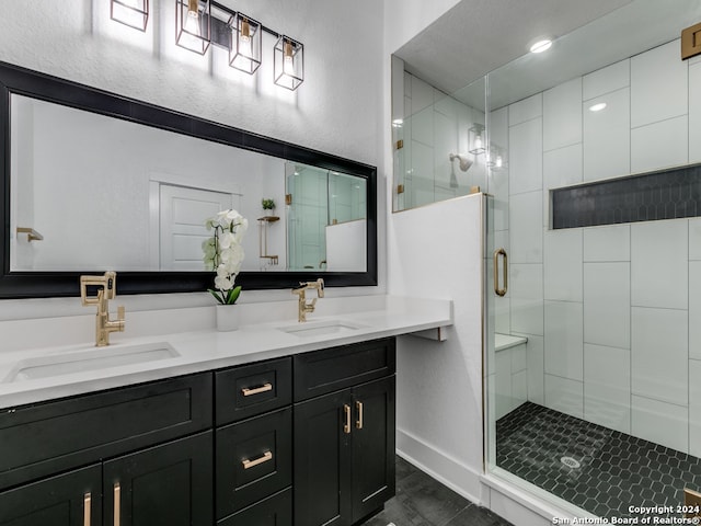 bathroom with vanity and a shower with door