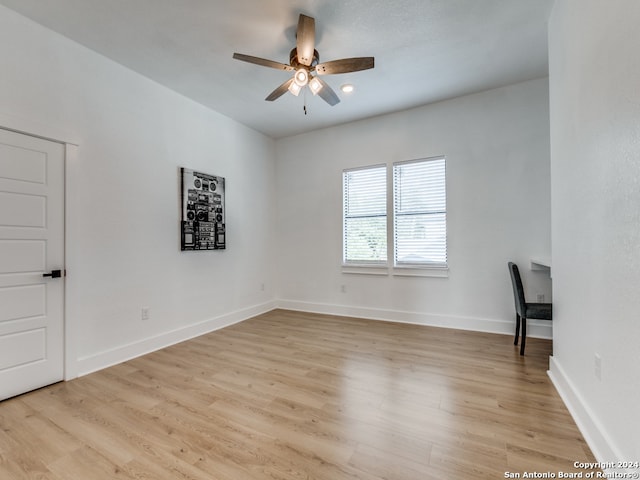 spare room with light hardwood / wood-style flooring and ceiling fan