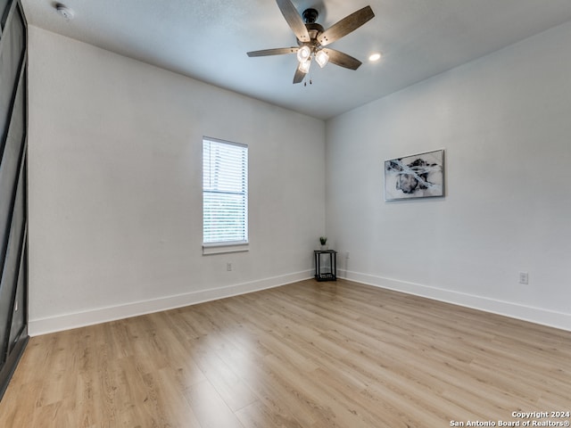 empty room with light hardwood / wood-style floors and ceiling fan