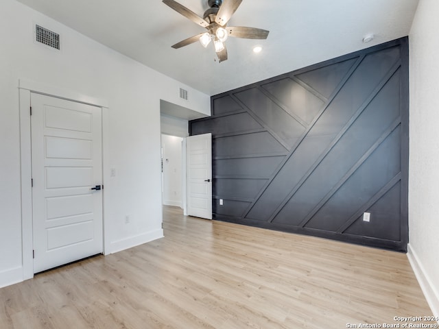 interior space with ceiling fan and light hardwood / wood-style flooring