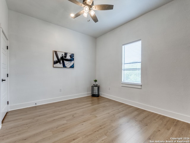 empty room with ceiling fan and light wood-type flooring