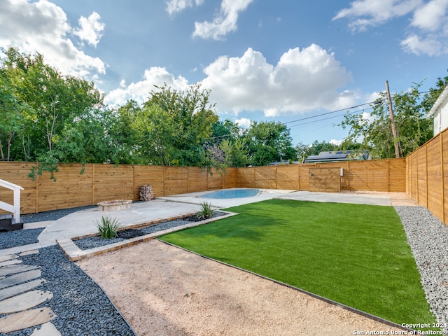 view of yard featuring a fenced in pool and a patio area