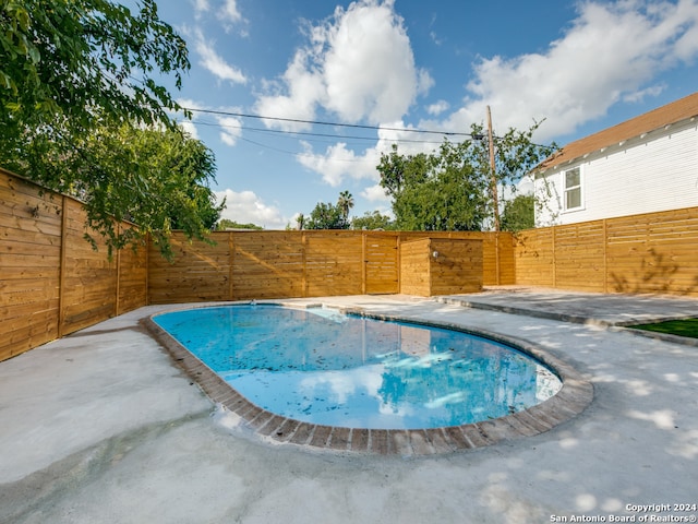 view of swimming pool with a patio