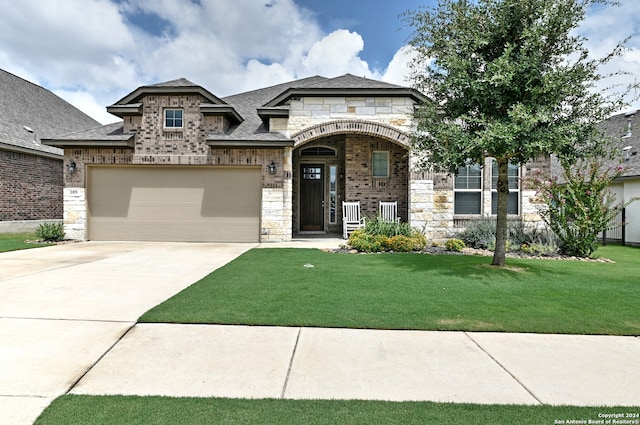 view of front of house with a front yard and a garage