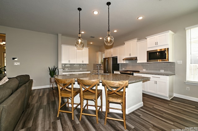 kitchen with dark wood-type flooring, stainless steel appliances, and white cabinets