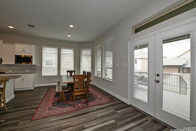 dining room featuring french doors, dark hardwood / wood-style flooring, and plenty of natural light