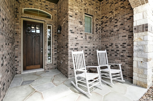 view of exterior entry featuring a porch