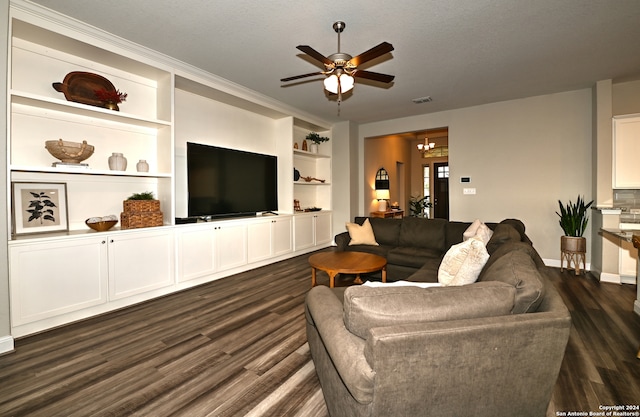 living room with a textured ceiling, ceiling fan with notable chandelier, dark hardwood / wood-style flooring, built in features, and ornamental molding