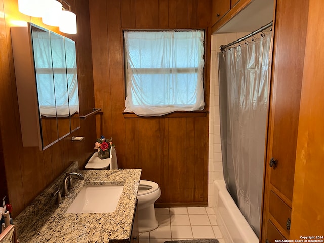 full bathroom featuring tile patterned floors, toilet, shower / tub combo, wood walls, and vanity