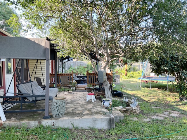 view of yard with a patio and a trampoline