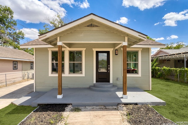 bungalow-style home featuring a front yard