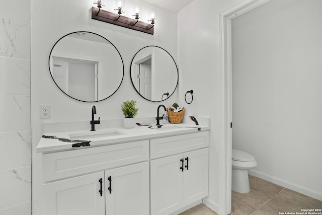 bathroom with vanity, toilet, and tile patterned floors