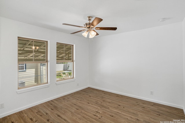 spare room featuring hardwood / wood-style floors and ceiling fan