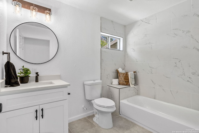 full bathroom featuring tiled shower / bath, vanity, toilet, and tile patterned flooring