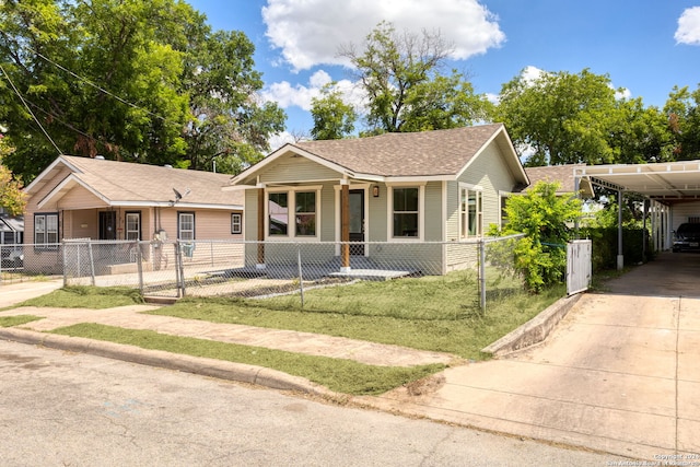 view of front facade featuring a front yard, a carport, and a porch