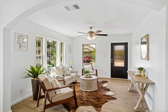 living room featuring ceiling fan and light hardwood / wood-style floors