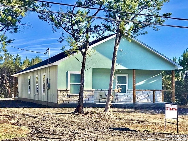 view of side of property featuring a porch