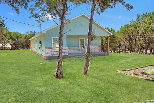 exterior space with a yard and stucco siding