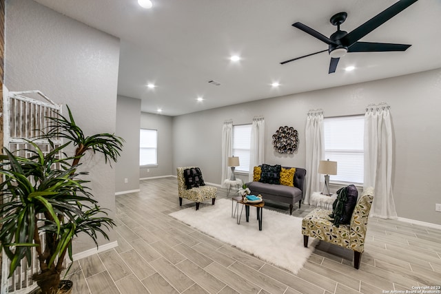 living room featuring ceiling fan and light hardwood / wood-style floors