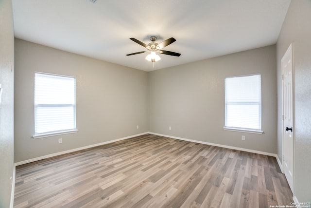 unfurnished room with light wood-type flooring, a healthy amount of sunlight, and ceiling fan