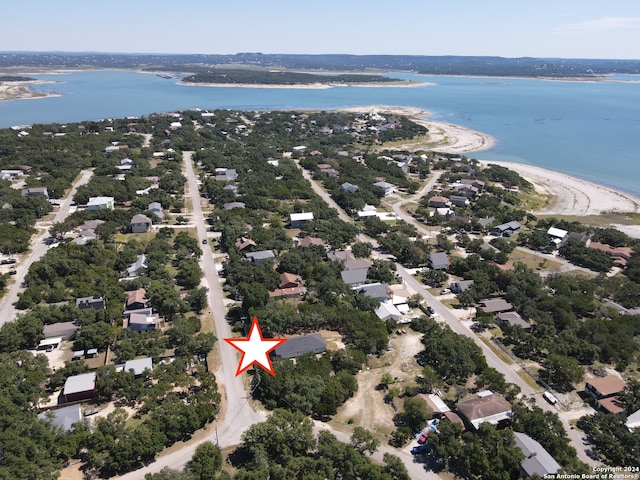 birds eye view of property with a view of the beach and a water view