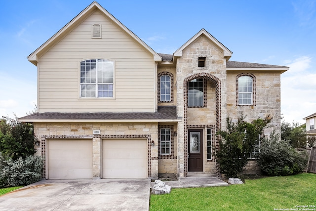 view of front of property featuring a garage and a front lawn